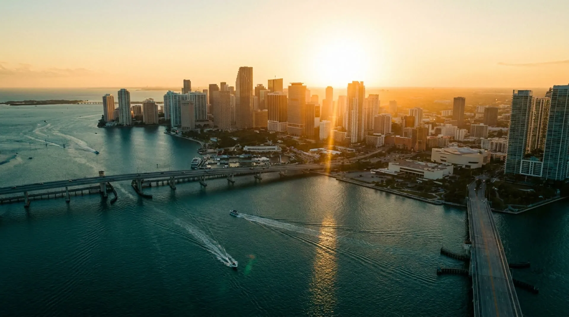 Aerial view of the downtown Miami skyline across Biscayne Bay at dusk